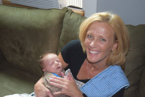 Portland lactation consultant Tina Buie holding a newborn baby